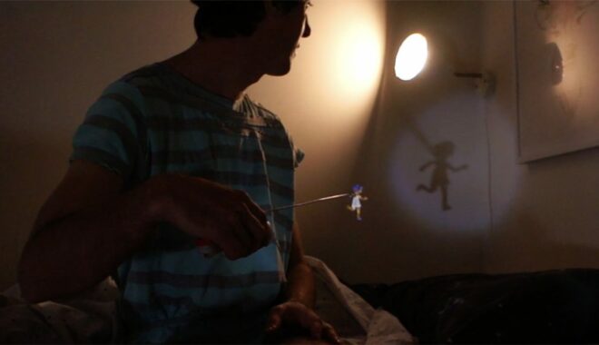 Artist showing shadow puppetry