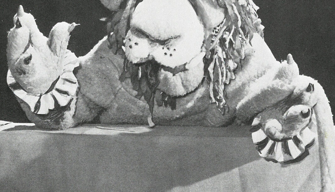An image of 'Circus Star' by Dorothy Rickards. A puppet with a large nose and frilled sleeves poses on a striped counter.