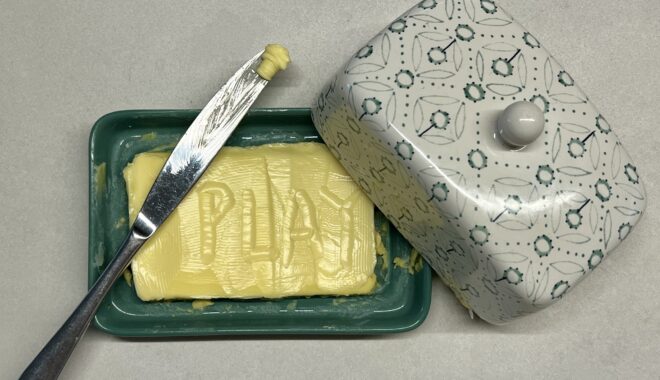 Photo: Lauren Swain. The word 'play' formed in a butter dish.