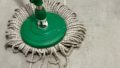 Photo: Lauren Swain. The word 'play' formed out of the strings on a mop.
