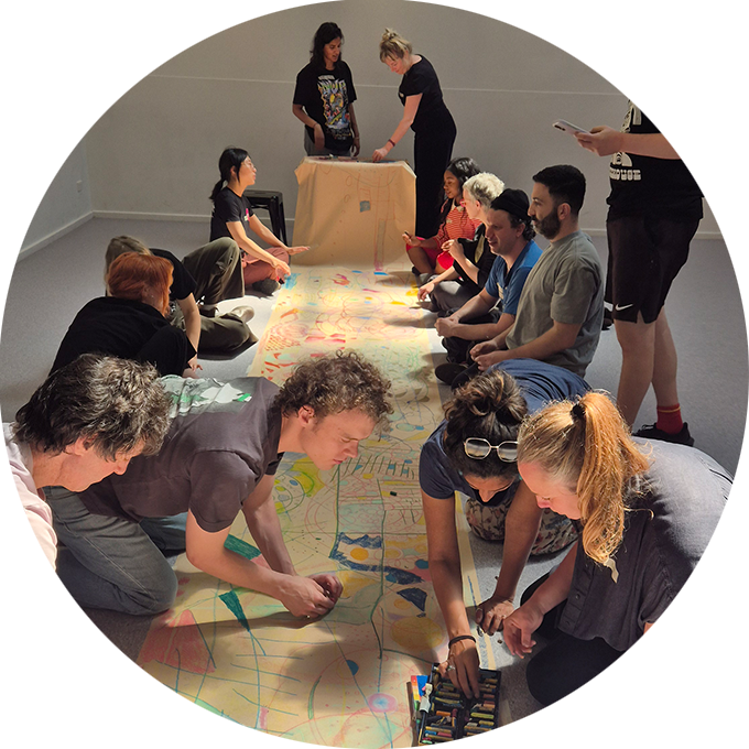 Creative Exchange photo: Polyglot and St Martins artists draw together on a long sheet of parchment paper. Photo: courtesy of Emily Tomlins.