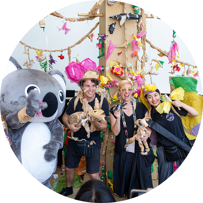 Paper Planet workshop photo: Polyglot and Acchi Cocchi artists pose with a person in a Koala costume. Photo: courtesy of DFAT.