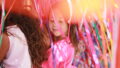 Tangle production photo: Ethan David, NYU Abu Dhabi Arts Center. A child in a pink t-shirt stands among hundreds of strands of colourful elastic, their eyes closed.